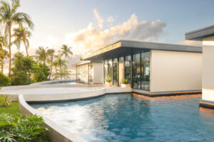 View of an exterior of a house with a pool.